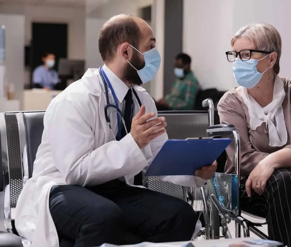 elderly-woman-using-wheelchair-talking-to-geriatric